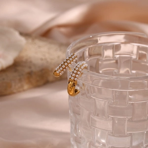 18K gold plated stainless steel hoop earrings with white pearls on a glass rim