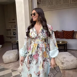 Elegant light green floral maxi dress with deep V-neck and puff long sleeves on model