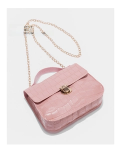Detailed view of pink crocodile embossed texture and gold metal twist lock on chain bag