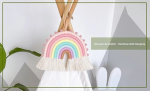 Detail of bohemian rainbow wall hanging with colorful cotton rope and pom-poms