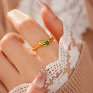 Gros plan détaillé d'une bague branche vintage avec pierre goutte verte et zircone