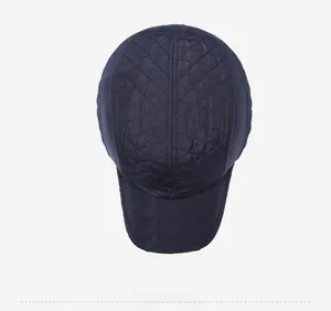 Close-up of diamond quilted baseball cap with detailed embroidery on navy blue fabric