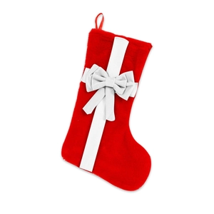 Plush red Christmas stocking with a large white fabric bow for festive home decoration