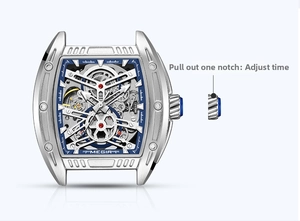 Close-up of silver tonneau mechanical watch case with skeleton dial and crown function