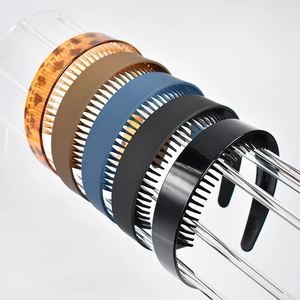 Detailed view of four multi-colored non-slip headbands with teeth on acrylic stand