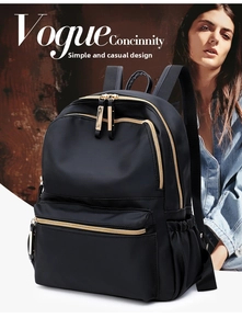 Detail view of black nylon backpack with golden zippers and multi-pocket structure