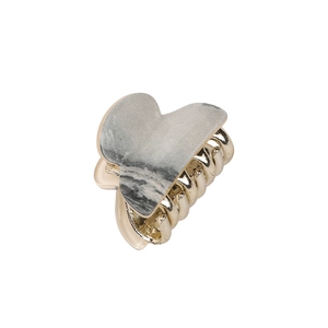 Golden heart-shaped hair claw clip with grey marble texture on a white background