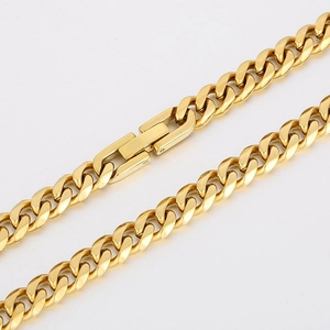 Close-up of golden Cuban link necklace showing polished metal texture and box clasp