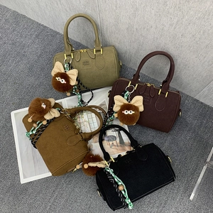 Detail of Boston bags in four colors with suede texture and plush monster charms