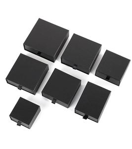 Detail view of black matte drawer jewelry boxes with ribbon pull handles in various sizes