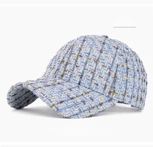 Detailed texture of sky blue tweed baseball cap featuring multicolor woven threads