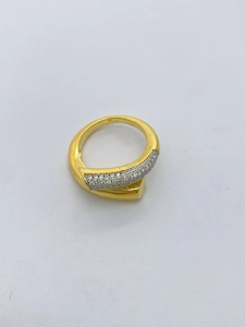 Detail of 18k gold plated bypass ring with micro-paved sparkling cubic zirconia stones