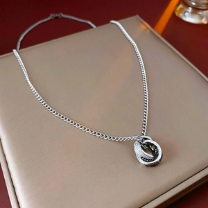 Détail du collier à trois anneaux entrelacés en métal argenté avec détails en zircone
