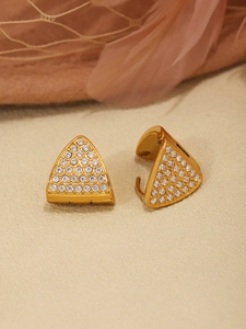 Close-up of golden triangle earrings with sparkling pave-set white zircons and hoop closure