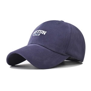 Close-up of white BOSTON 1630 3D embroidery on a navy blue cotton baseball cap