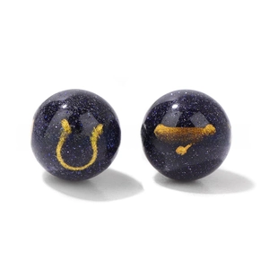 Macro shot of 10mm blue goldstone beads featuring golden Taurus zodiac symbol and star map