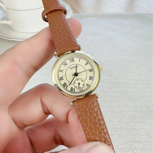 Classic gold roman numeral quartz watch with brown leather strap and beige dial