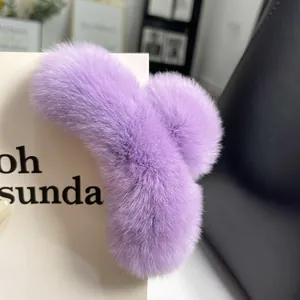 Close-up of a light purple plush claw clip showing soft fur texture and grip teeth
