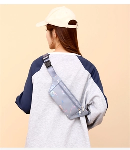 Detail view of gray sports waist bag with colorful prints and adjustable buckle strap