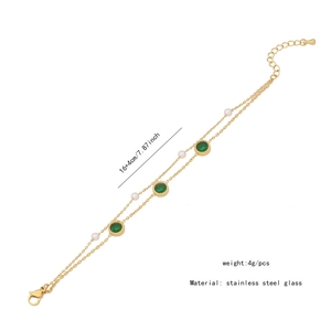 Detail showing emerald green stars and pearls on a double-layer golden stainless steel chain