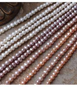Macro shot of natural freshwater pearls in white, lavender, and champagne on stone