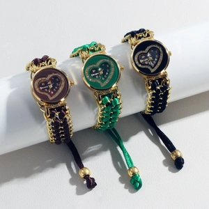 Detailed view of woven quartz watches in red, green, and black with heart pattern