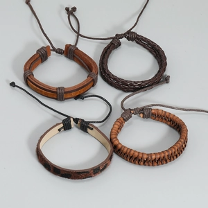 Set of four handmade braided brown leather bracelets with multi-layer vintage designs