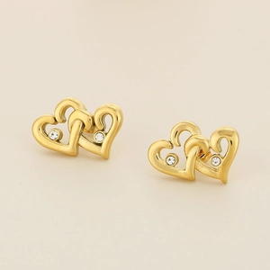 Macro shot of 18K gold double interlocking heart earrings with sparkling white crystals