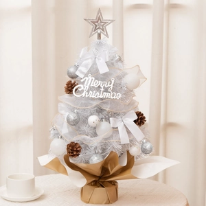 Close-up of 55cm mini white Christmas tree with silver ornaments and pine cones