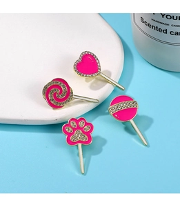Detail of four pink candy and cat paw enamel brooches with rhinestones and gold plating