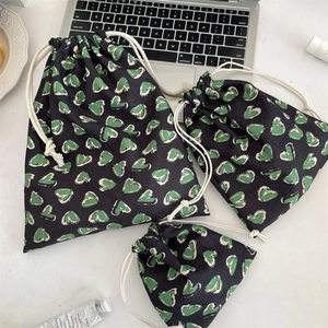 Three-piece set of heart-print drawstring storage bags in various sizes for travel