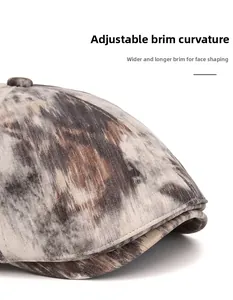 Close-up of the vintage cap showing the wide curved brim and textured distressed fabric