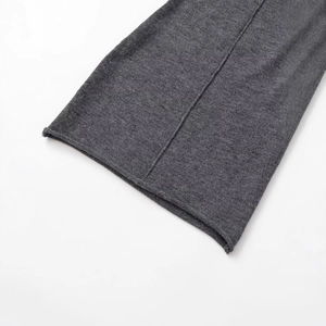 Close-up of a soft ribbed crew neck dress showing cuff texture in dark grey knit fabric