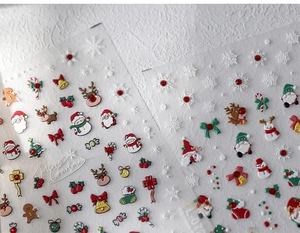 Macro view of 3D embossed Christmas nail stickers with Santa and snowman details
