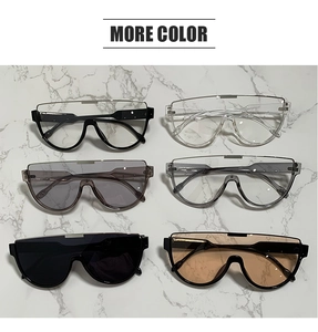 Flat lay of oversized shield aviator sunglasses in six colors on marble background