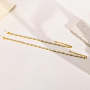 Close-up of gold plated tennis bracelets with white zircon stones and lobster clasp