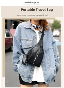 Detail of black crossbody chest bag with small hanging pouch on a blue denim jacket