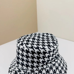 Close-up of houndstooth pattern fabric texture on a reversible bucket hat for women