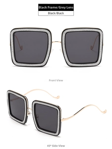 Detail view of square sunglasses with silver glitter frame and wavy gold metal temples