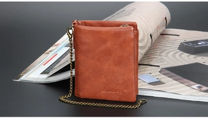 Short brown leather wallet for men featuring a vintage metal chain and hook detail