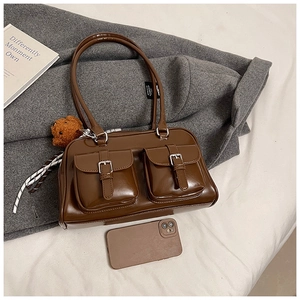 Brown patent leather underarm bag featuring vintage cargo pockets with silver buckles
