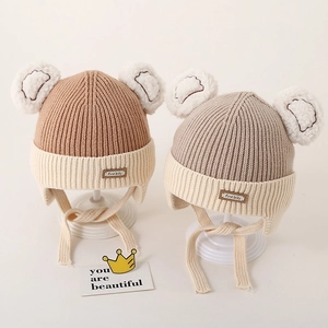 Winter knit baby hat with earflaps and fuzzy bear ears for infants in earthy tones