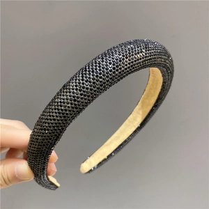 Close-up of padded headband with shimmering black rhinestones and soft inner velvet lining