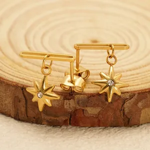 Elegant 18K gold-plated star stud earrings with white zircon on a natural wood surface