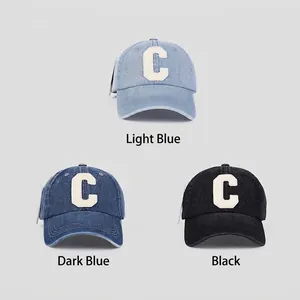 Three washed denim baseball caps with C letter embroidery in light blue, dark blue and black