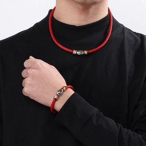 Braided red leather necklace and bracelet set with tricolor metal beads on model