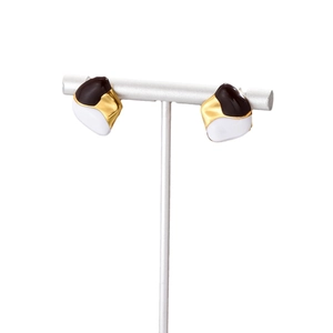 French retro geometric enamel earrings in black white and gold hanging on T-stand