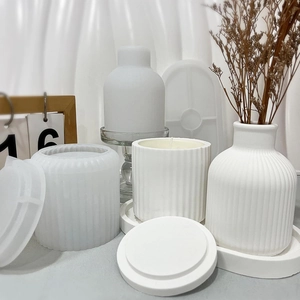 Detail of striped plaster candle jar, vase and silicone molds for DIY resin casting