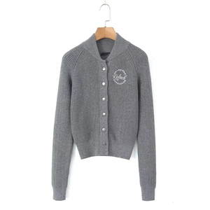 Detail of grey ribbed knit cardigan with silver metal buttons and white logo embroidery