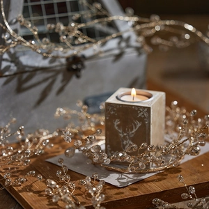 Close-up of champagne gold beaded festive branch with crystal beads for holiday decor
